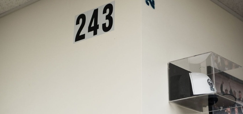 The numbers "243" stenciled to a wall in Roots Charter School. "2" is the number of letters needed to spell "we;" "4" is the number of letters needed to spell "love;" and "3" is the number of letters needed to spell "you."